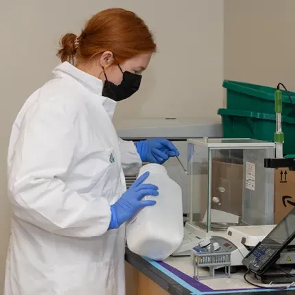 A student weighs a powder compound